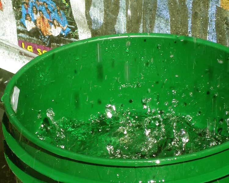 Snow Melting in a Green Bucket